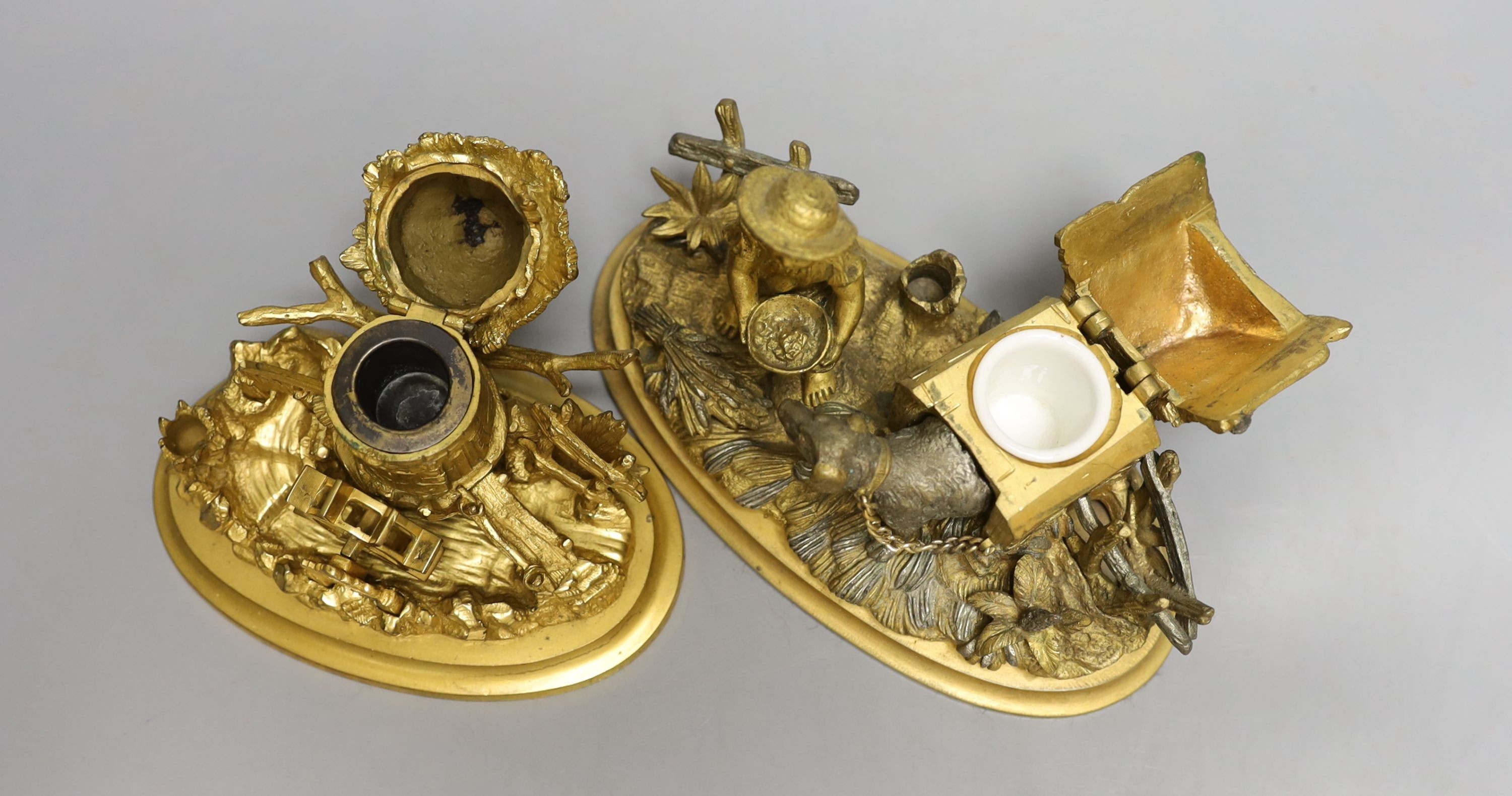 Two 19th century ormolu inkwells, modelled as a dog in a kennel, a water mill together with a chamberstick